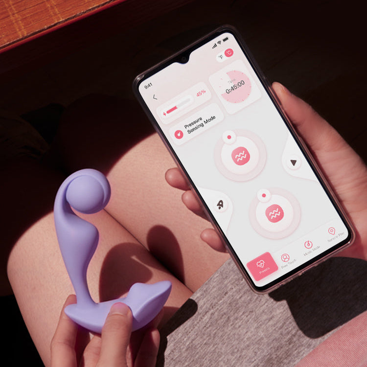 Person holding a smartphone with a device app on screen and a purple device in hand.